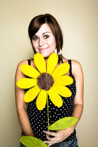 Woman with large paper sunflower